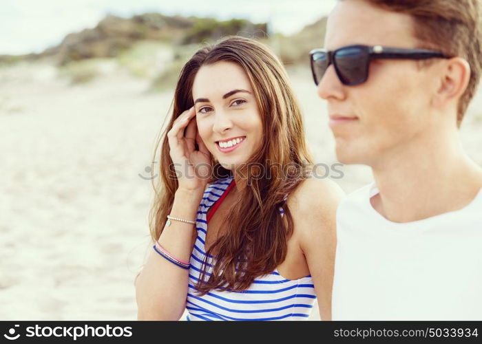 Romantic young couple on the beach. Portraits of romantic young couple on the beach