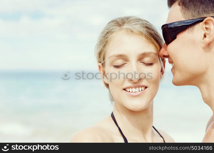 Romantic young couple on the beach. Portraits of romantic young couple on the beach