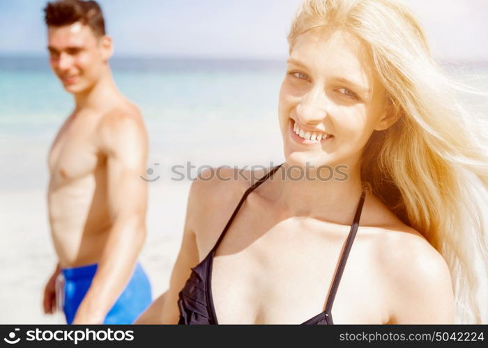 Romantic young couple on the beach. Portraits of romantic young couple on the beach