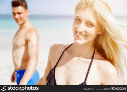 Romantic young couple on the beach. Portraits of romantic young couple on the beach