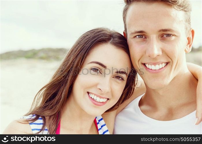 Romantic young couple on the beach. Portraits of romantic young couple on the beach
