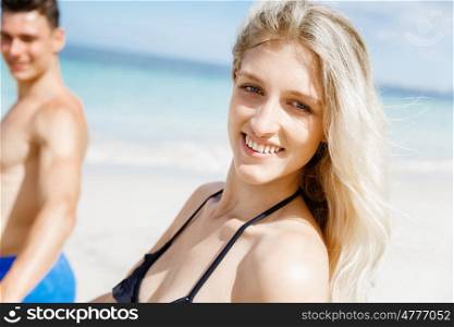 Romantic young couple on the beach. Portraits of romantic young couple walking on the beach
