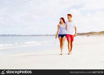 Romantic young couple on the beach. Romantic young couple on the beach walking along the shore