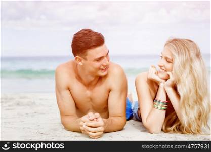 Romantic young couple on the beach. Romantic young couple on the beach looking at each other