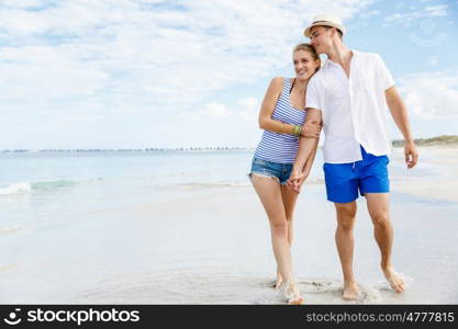 Romantic young couple on the beach. Romantic young couple on the beach waloking along the shore