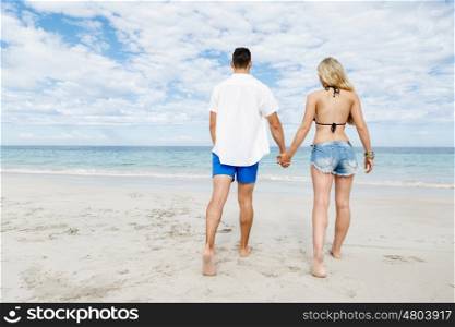 Romantic young couple on the beach. Romantic young couple on the beach waloking along the shore