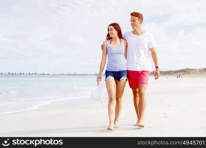 Romantic young couple on the beach. Romantic young couple on the beach walking along the shore