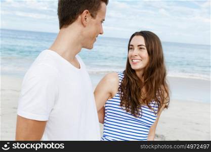 Romantic young couple on the beach. Romantic young couple on the beach standing next to the ocean