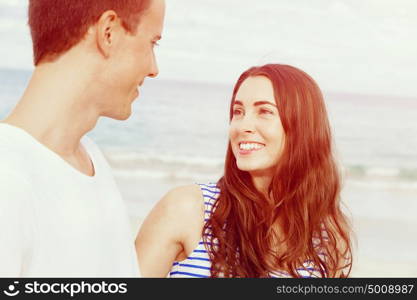 Romantic young couple on the beach. Romantic young couple on the beach looking at each other