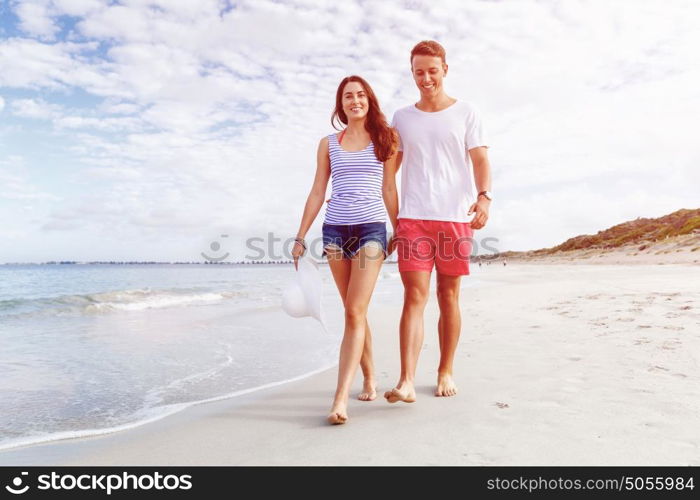 Romantic young couple on the beach. Romantic young couple on the beach walking along the shore