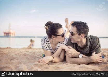 Romantic, young couple relaxing on a beach