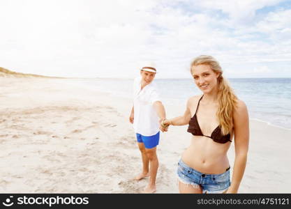 Romantic young couple sitting on the beach. Romantic young couple sitting on the beach looking at each other