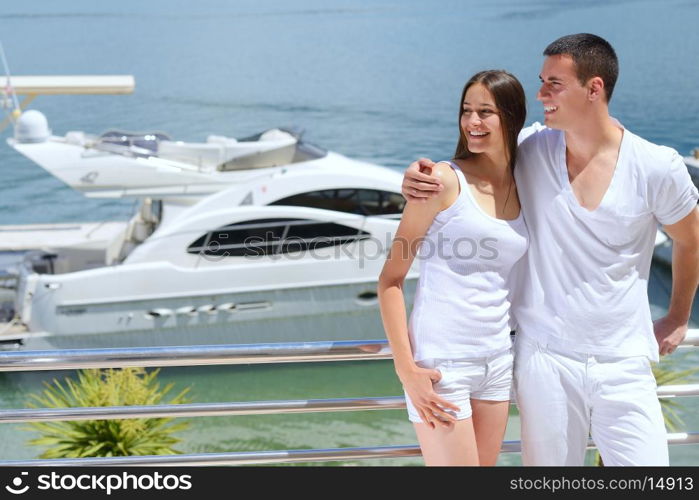 Romantic young couple spending time together and relaxing on yacht