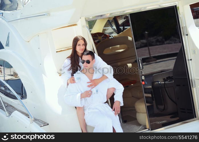 Romantic young couple spending time together and relaxing on yacht