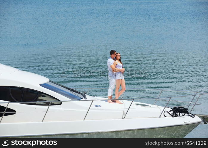 Romantic young couple spending time together and relaxing on yacht