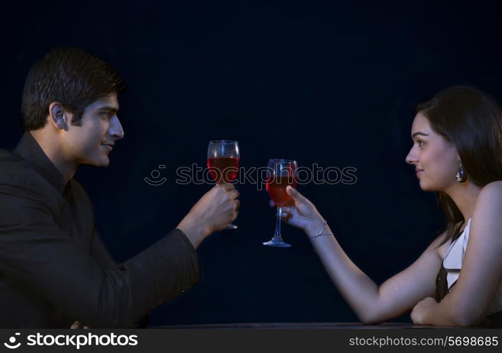 Romantic young couple toasting on date
