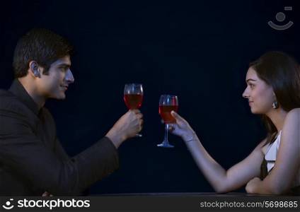 Romantic young couple toasting on date