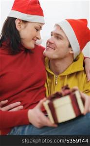 Romantic young couple with Christmas present box