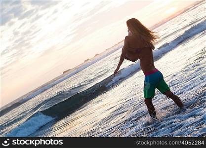 Romantic young man carrying girlfriend in arms on beach, Nosara, Guanacaste, Costa Rica