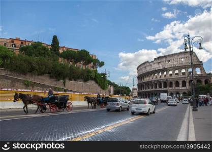 Rome, Italy - 17 october 2012: Busy street near Colosseum - ancient amphitheatre in the centre of the city of Rome