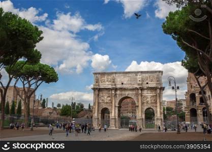 Rome, Italy - 17 october 2012: Tourists walking near Constantine&rsquo;s arc in Rome - triumphal arch in Rome, situated between the Colosseum and the Palatine Hill