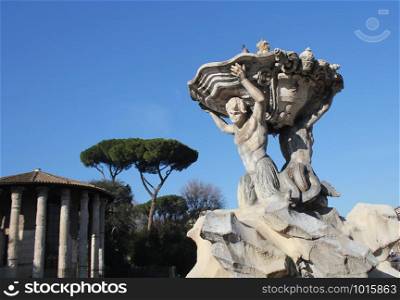 ROME, ITALY- DECEMBER 29 2018: Fountain of the Tritons and Temple of Hercules Victor, Rome Italy .. ROME, ITALY- DECEMBER 29 2018: Fountain of the Tritons and Temple of Hercules Victor, Rome Italy