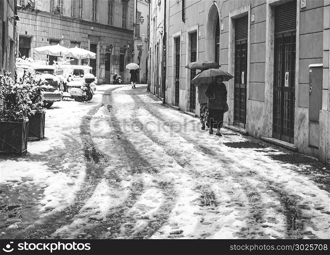 Rome, Italy, february 26th 2018: elderly ladies with an umbrella try to walk in an alley during the unusual snowfall on February 26, 2018 in Rome, Italy