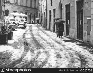 Rome, Italy, february 26th 2018: elderly ladies with an umbrella try to walk in an alley during the unusual snowfall on February 26, 2018 in Rome, Italy