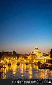 ROME, ITALY - JUNE 2020: sunset panorama on Tiber river bridge with Saint Peter Cathedral dome (Vatican City) in background - Rome, Italy