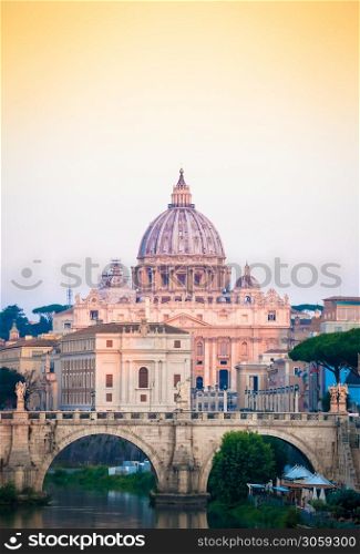 ROME, ITALY - JUNE 2020: sunset panorama on Tiber river bridge with Saint Peter Cathedral dome (Vatican City) in background - Rome, Italy
