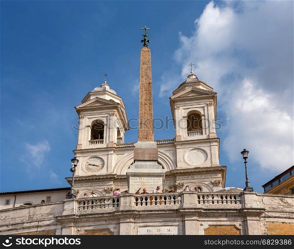 ROME - OCTOBER 31, 2013: Trinita dei Monti Church on top of Spanish Steps in Rome, Italy. With 138 steps in total, the Spanish Steps of Rome are the longest and widest outdoor steps in Europe.