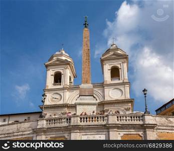 ROME - OCTOBER 31, 2013: Trinita dei Monti Church on top of Spanish Steps in Rome, Italy. With 138 steps in total, the Spanish Steps of Rome are the longest and widest outdoor steps in Europe.