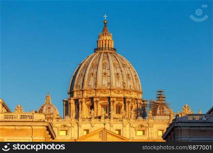 Rome. Saint Peter&rsquo;s Cathedral.. A view in the rays of the rising sun on dome of St. Peter&rsquo;s Cathedral. Rome. Vatican. Italy.