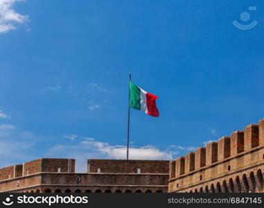 Rome. The Italian flag on the tower.. National Italian flag on the fortress wall against a blue sky on sunny day. Rome.