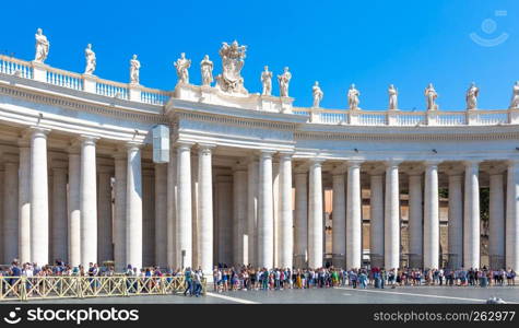 ROME, VATICAN STATE - AUGUST 24, 2018: long line of people waiting in front of Saint Peter Basilica entrance. Concept for overtourism and mass-tourism.