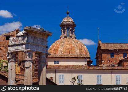 Rome. View of the old town.. A view of the tiled roofs and an antique arch in the old town. Rome. Italy.
