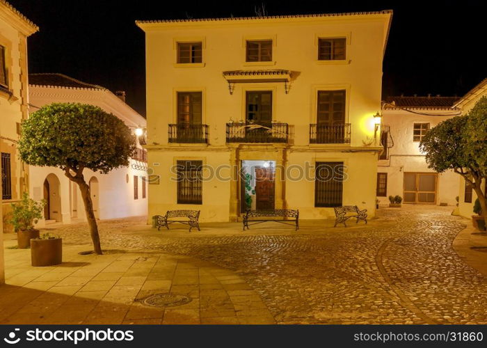 Ronda. Village street at night.. Traditional narrow village street with glowing lanterns in Ronda. Spain. Andalusia.