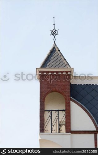 Roof corner top niche with decorative ornaments and blue tiles at Bodegraven, the Netherlands on september 6, 2010