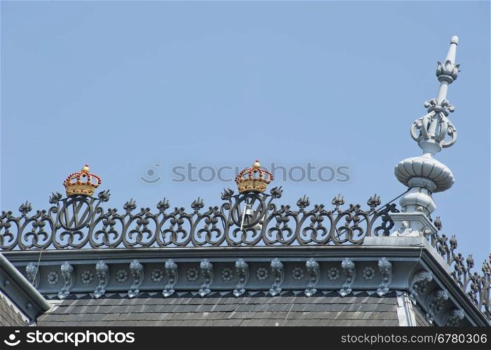 Roof top with decorative ornaments and golden crowns at Amsterdam, the Netherlands on june 23, 2010