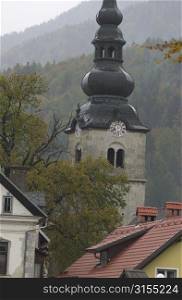 Roof tops and a clock tower in a town in Slovenia