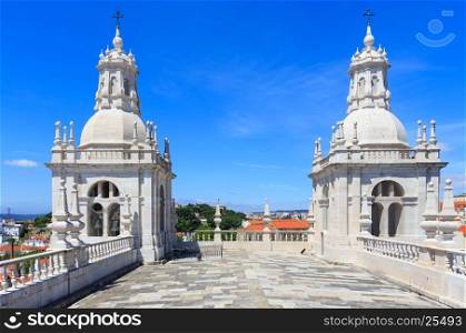 Roof with white bell towers on blue sky background. Monastery of St. Vincent Outside the Walls, or Church (Iglesia) de Sao Vicente de Fora in Lisbon, Portugal.