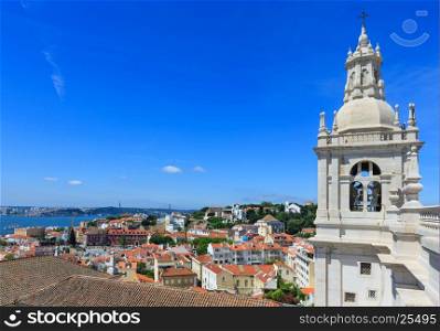 Roof with white tower and Lisbon cityscape. Monastery of St. Vincent Outside the Walls, or Church (Iglesia) de Sao Vicente de Fora, Portugal. All people are unrecognizable.