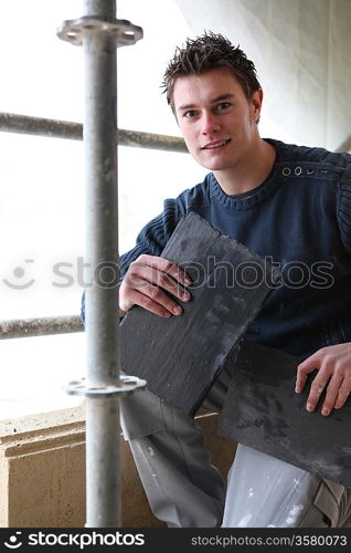 Roofer with slate tiles