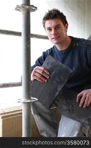 Roofer with slate tiles