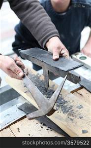 Roofers cutting slate to size