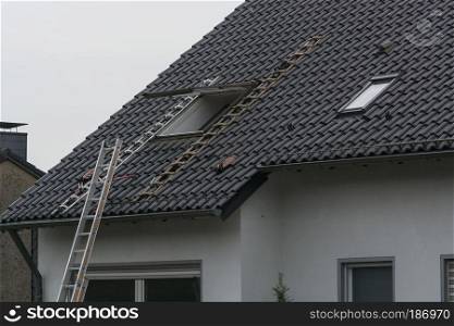 Roofing, installation or repair of a roof window on a pitched roof