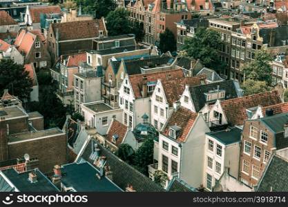 Roofs and facades of Amsterdam. City view from the bell tower of the church Westerkerk, Holland, Netherlands. Toning in cool tones