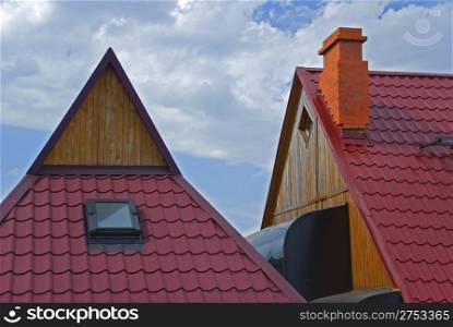 Roofs of houses covered red tile on a background of the sky