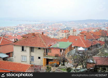 Rooftop view of small seaside town in a foggy day