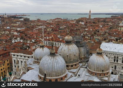 Rooftop views of canals and ancient architecture in Venice, Italy. Venice is a city in northeastern Italy sited on a group of 118 small islands separated by canals and linked by bridges.